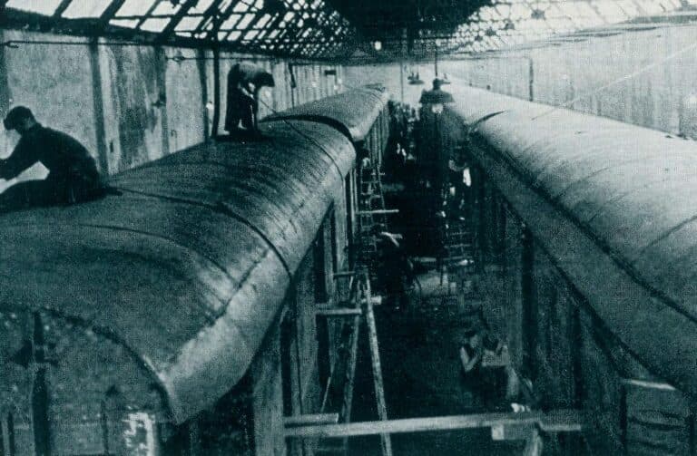 Two railway carriages in the factory assembly hall